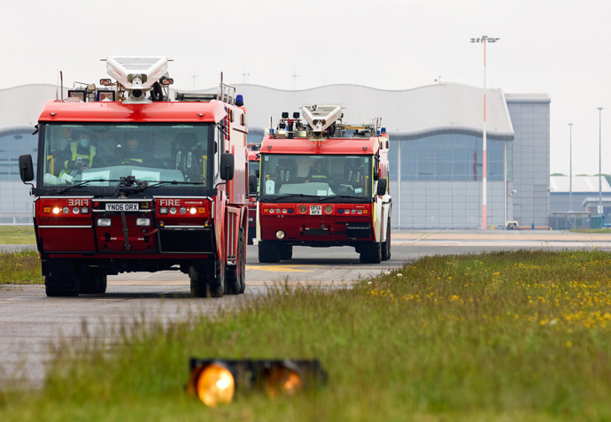 Fire Trucks Driving Down The Runway